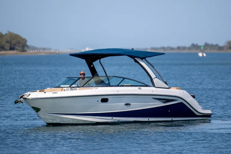 Slide: The Image of 2022 Sea Ray SLX 280 boat cruising on calm blue waters. - 4