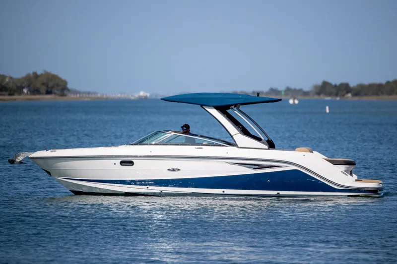 Slide: The Image of 2022 Sea Ray SLX 280 boat cruising on calm blue waters. - 5