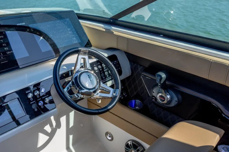 Slide: The Image of Cockpit of 2022 Sea Ray SLX 280 boat with steering wheel and control panel. - 16