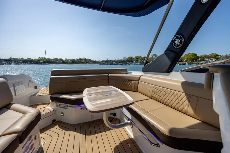 Slide: The Image of Luxurious 2022 Sea Ray SLX 280 boat interior with elegant seating and table on the water. - 13