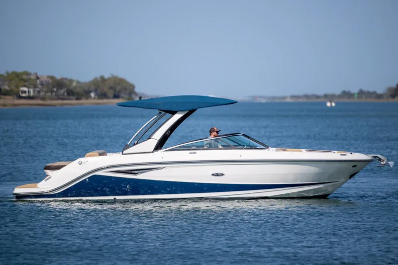 Slide: The Image of 2022 Sea Ray SLX 280 boat cruising on a calm blue lake. - 1