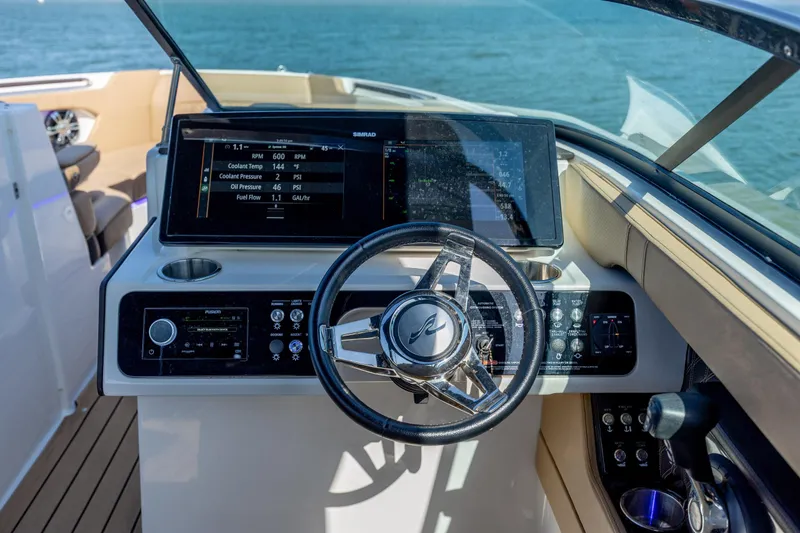 Slide: The Image of Cockpit of 2022 Sea Ray SLX 280 boat with modern controls and steering wheel. - 15