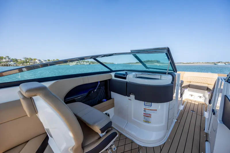 Slide: The Image of 2022 Sea Ray SLX 280 boat interior with luxurious seating and scenic water view. - 19