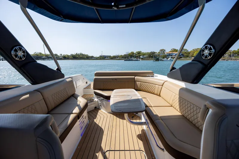 Slide: The Image of Luxurious 2022 Sea Ray SLX 280 boat interior with elegant seating and scenic water view. - 12