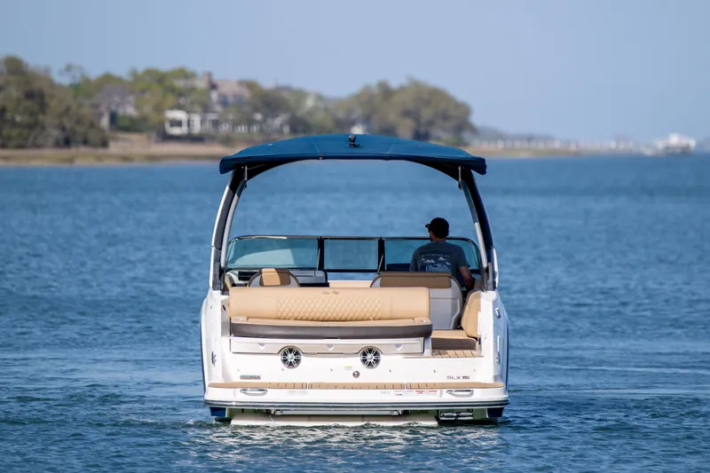 Slide: The Image of 2022 Sea Ray SLX 280 boat cruising on a calm blue lake. - 7