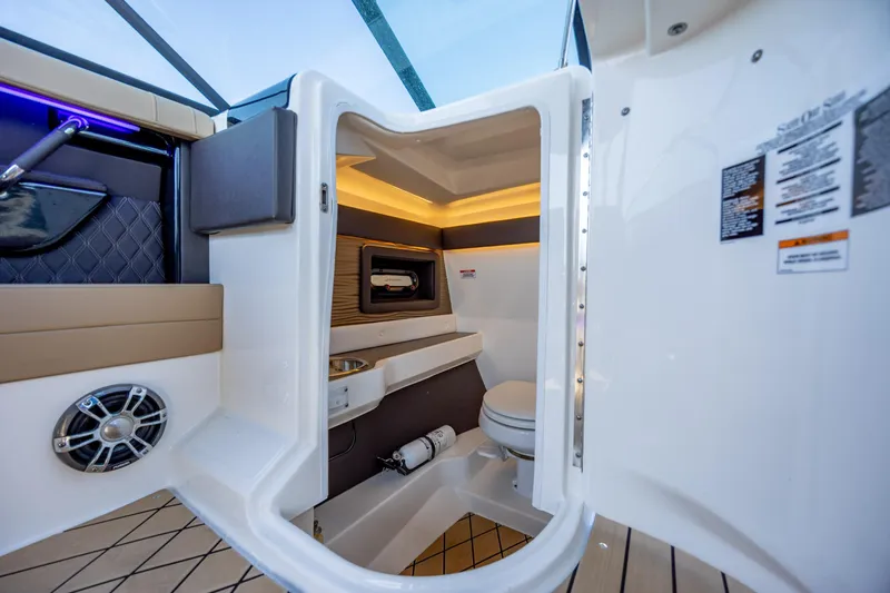 Slide: The Image of Interior of 2022 Sea Ray SLX 280 boat featuring a compact bathroom with modern amenities. - 20