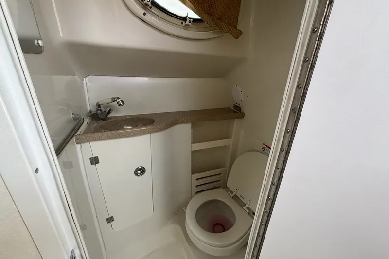 Slide: The Image of 2007 Pro-Line 29 Express boat bathroom with sink, toilet, and porthole window. - 15