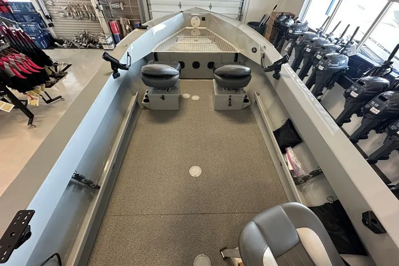 Slide: The Image of 2026 Hewescraft 180 Open Fisherman boat interior with seating and fishing equipment. - 4