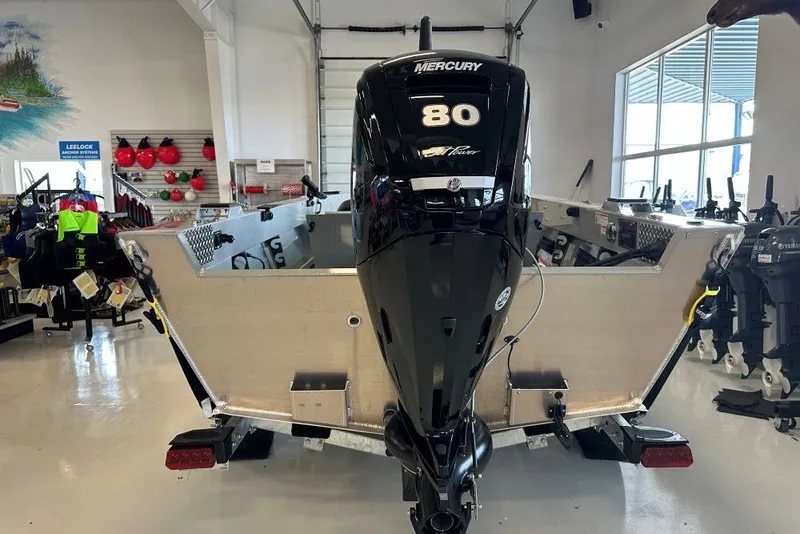 Slide: The Image of 2026 Hewescraft 180 Open Fisherman boat with Mercury 80 engine in showroom. - 3