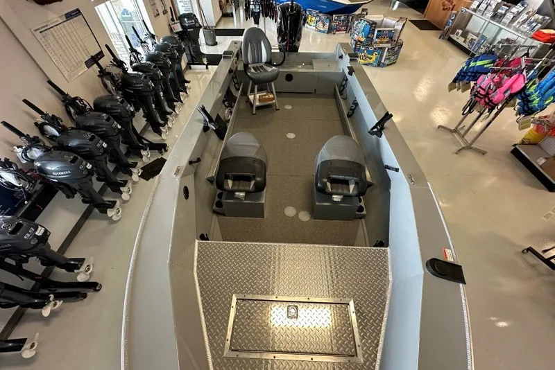 Slide: The Image of 2026 Hewescraft 180 Open Fisherman boat interior, showroom display with seating and equipment. - 5