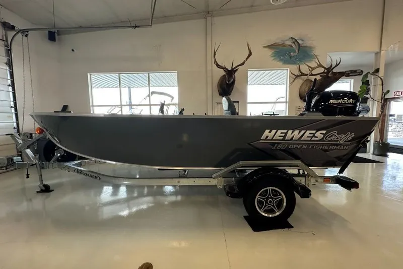 The Image of 2026 Hewescraft 180 Open Fisherman boat displayed indoors on a trailer. - 0