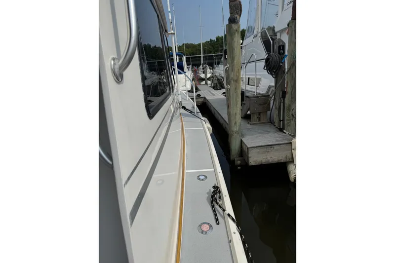 Slide: The Image of Side view of a 2001 Willis Beal 31 boat docked at a marina. - 5