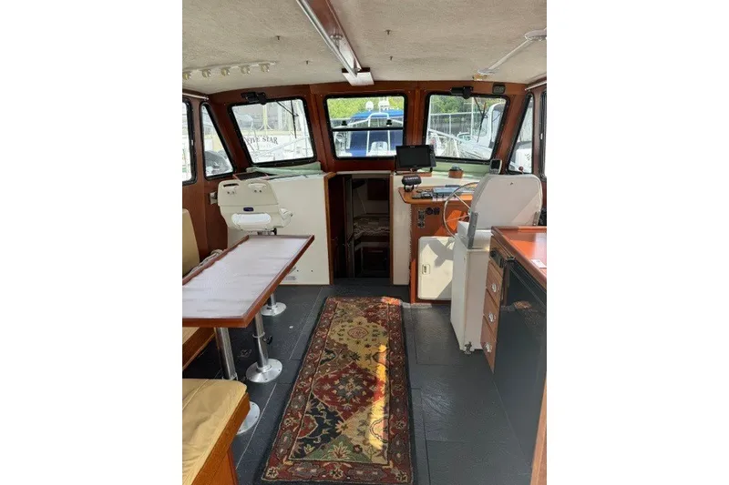 Slide: The Image of Interior of 2001 Willis Beal 31 boat with seating, table, and navigation equipment. - 9