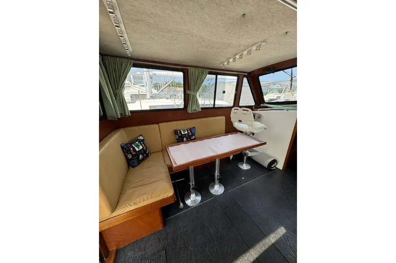 Slide: The Image of Interior of 2001 Willis Beal 31 boat with seating, table, and windows. - 14
