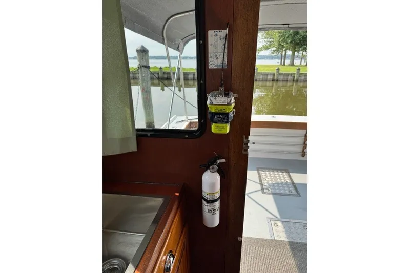 Slide: The Image of Interior of 2001 Willis Beal 31 boat with safety equipment and dock view. - 10