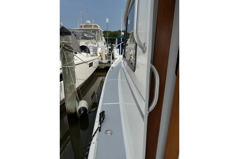 Slide: The Image of Side view of a 2001 Willis Beal 31 boat docked at a marina. - 4