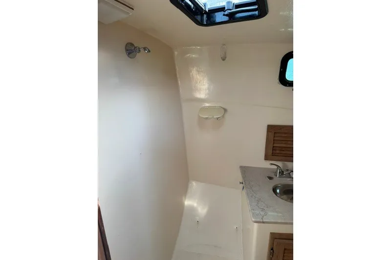 Slide: The Image of Interior of a 2001 Willis Beal 31 boat bathroom with sink and shower. - 17