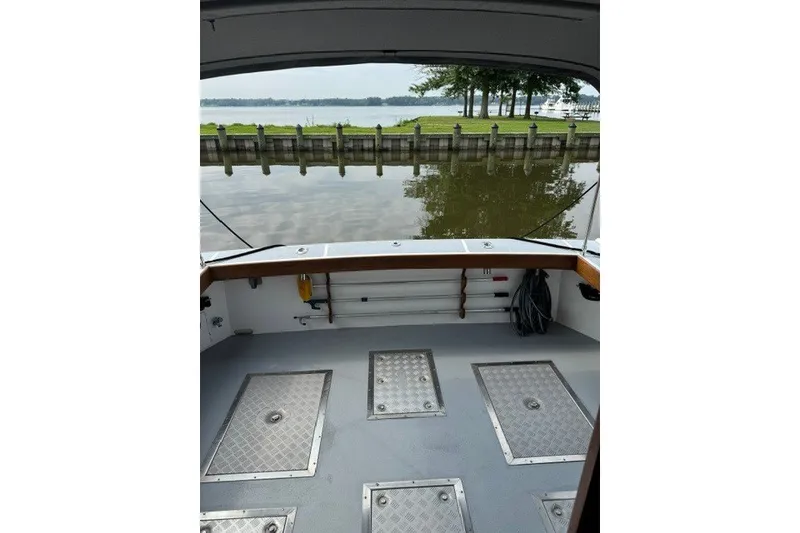Slide: The Image of Open deck of a 2001 Willis Beal 31 boat, overlooking calm waters. - 7