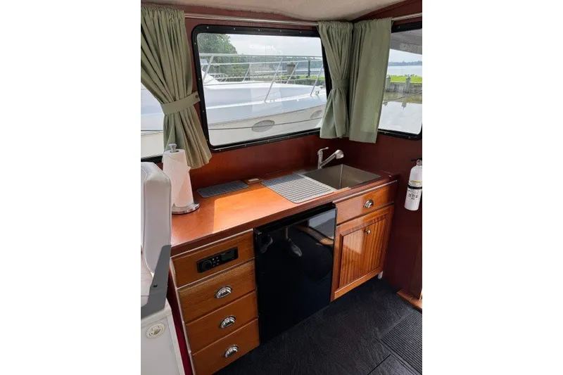 Slide: The Image of Willis Beal 31 boat interior kitchen with sink, cabinets, and window view, 2001 model. - 11
