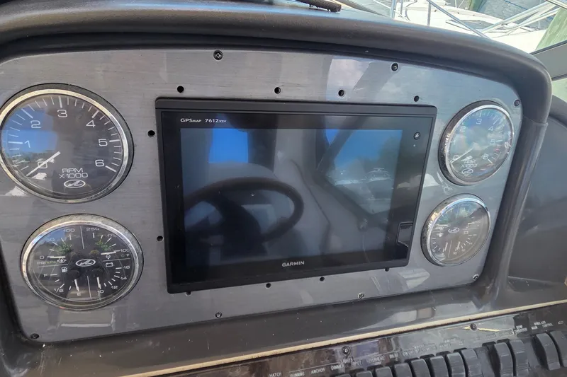Slide: The Image of Dashboard of a 2004 Sea Ray 380 Sundancer with Garmin GPS and gauges. - 30