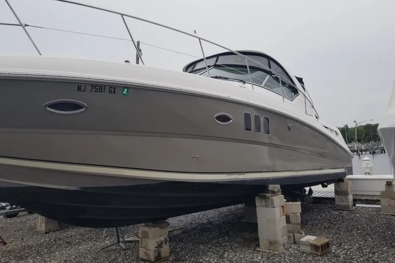 Slide: The Image of 2004 Sea Ray 380 Sundancer yacht on blocks, dockside view. - 4