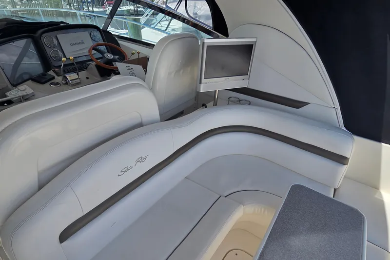 Slide: The Image of Interior of 2004 Sea Ray 380 Sundancer yacht with helm, seating, and monitor. - 31