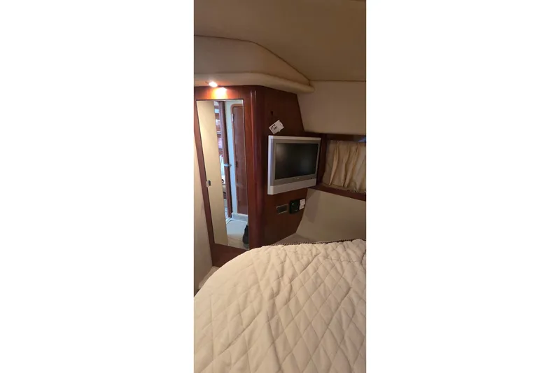 Slide: The Image of Interior of 2004 Sea Ray 380 Sundancer with TV, mirror, and cozy bedding. - 21