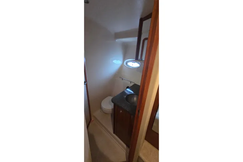 Slide: The Image of Bathroom interior of 2004 Sea Ray 380 Sundancer yacht with sink and toilet. - 23