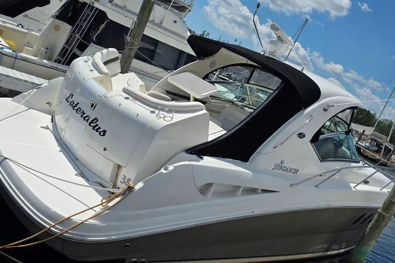 Slide: The Image of 2004 Sea Ray 380 Sundancer yacht docked at marina under blue sky. - 1