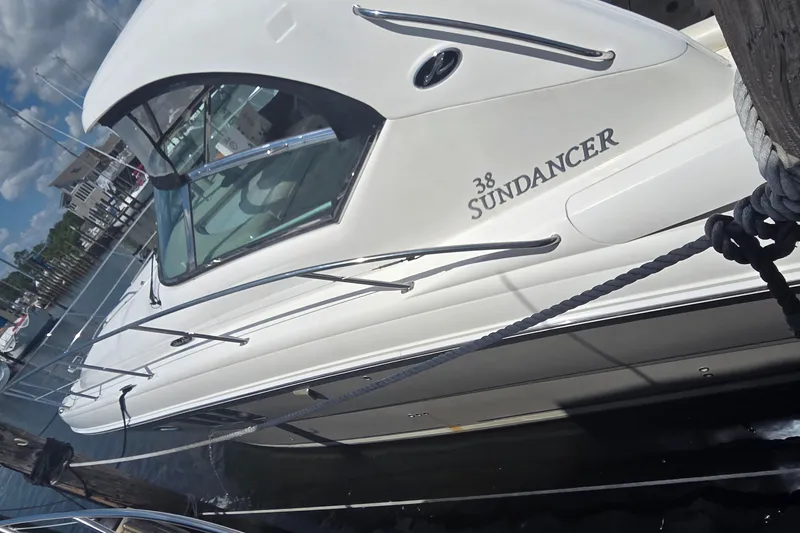Slide: The Image of 2004 Sea Ray 380 Sundancer yacht docked at marina under cloudy sky. - 2