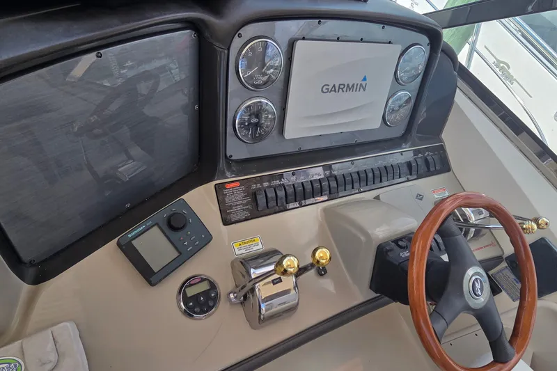 Slide: The Image of Control panel of 2004 Sea Ray 380 Sundancer with Garmin navigation system and wooden steering wheel. - 6
