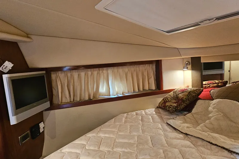Slide: The Image of Interior cabin of 2004 Sea Ray 380 Sundancer with cozy bed and TV. - 8