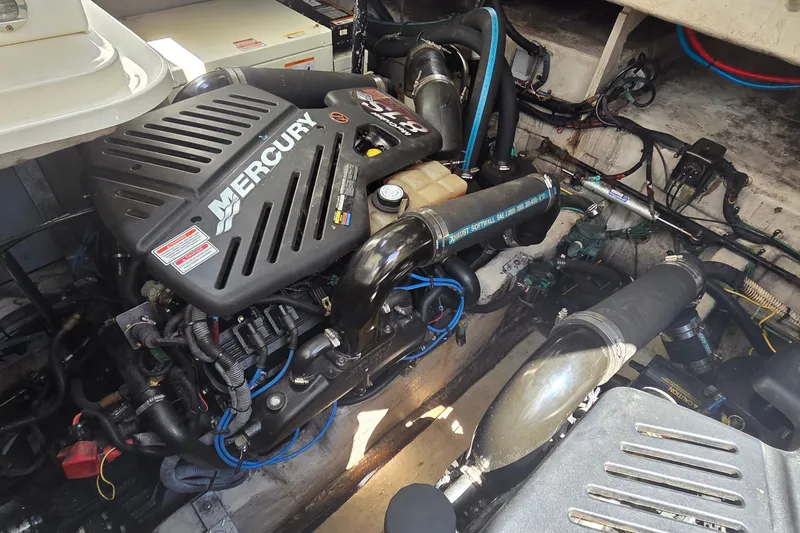 Slide: The Image of Engine compartment of a 2004 Sea Ray 380 Sundancer with Mercury engine components. - 13