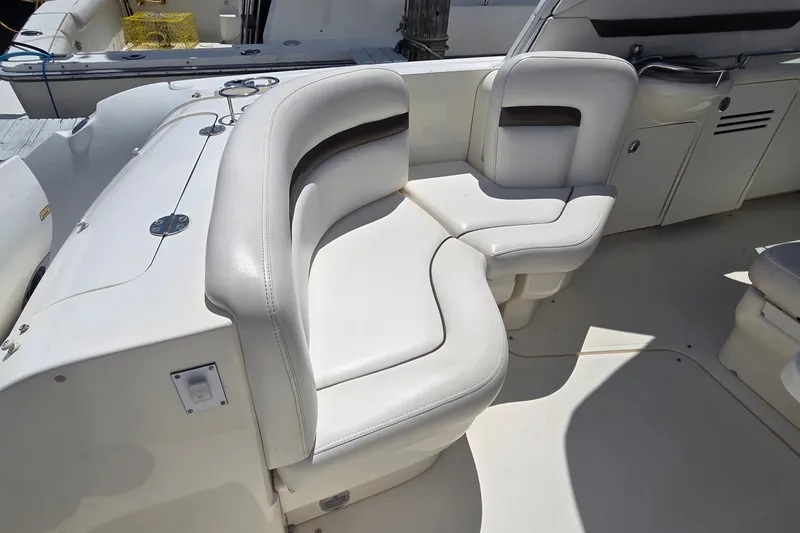 Slide: The Image of 2004 Sea Ray 380 Sundancer boat interior with white cushioned seating. - 28