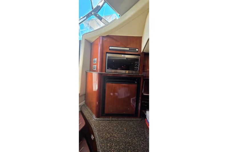 Slide: The Image of Interior of 2004 Sea Ray 380 Sundancer yacht with microwave and mini-fridge. - 24