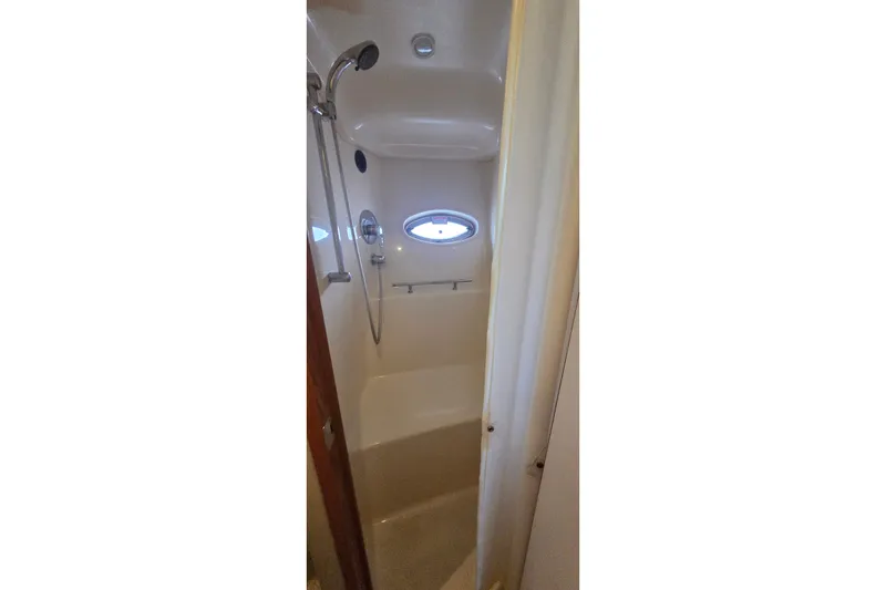 Slide: The Image of Shower area inside 2004 Sea Ray 380 Sundancer yacht with porthole window. - 22