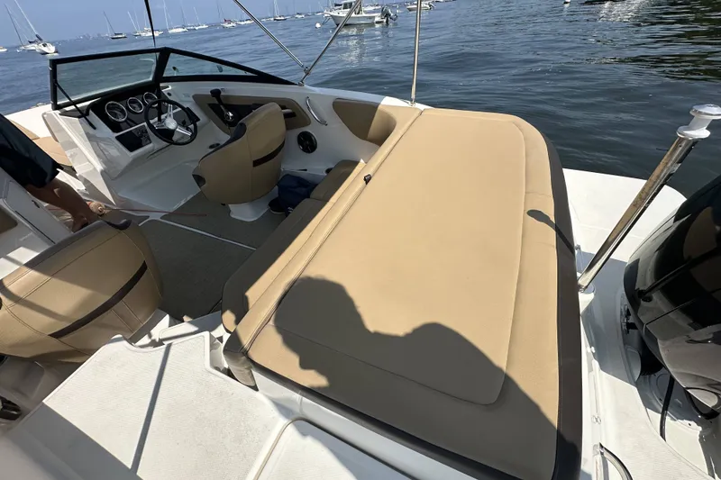 Slide: The Image of 2020 Sea Ray SPX 190 Outboard boat interior with tan seating and steering console. - 13