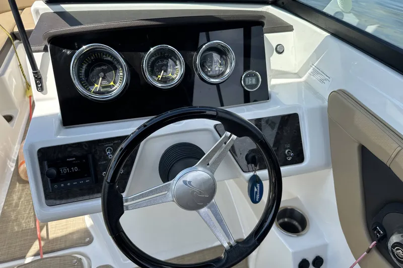 Slide: The Image of 2020 Sea Ray SPX 190 Outboard dashboard with steering wheel and gauges. - 6