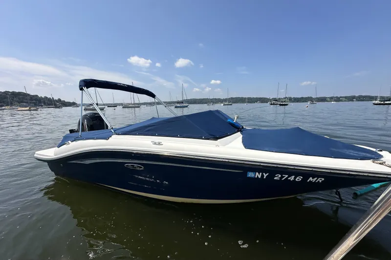 Slide: The Image of 2020 Sea Ray SPX 190 Outboard boat docked on a calm lake. - 14