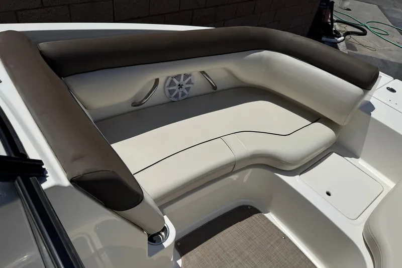 Slide: The Image of 2019 Bayliner 195 Deck Boat interior seating with cushioned upholstery and built-in speaker. - 14