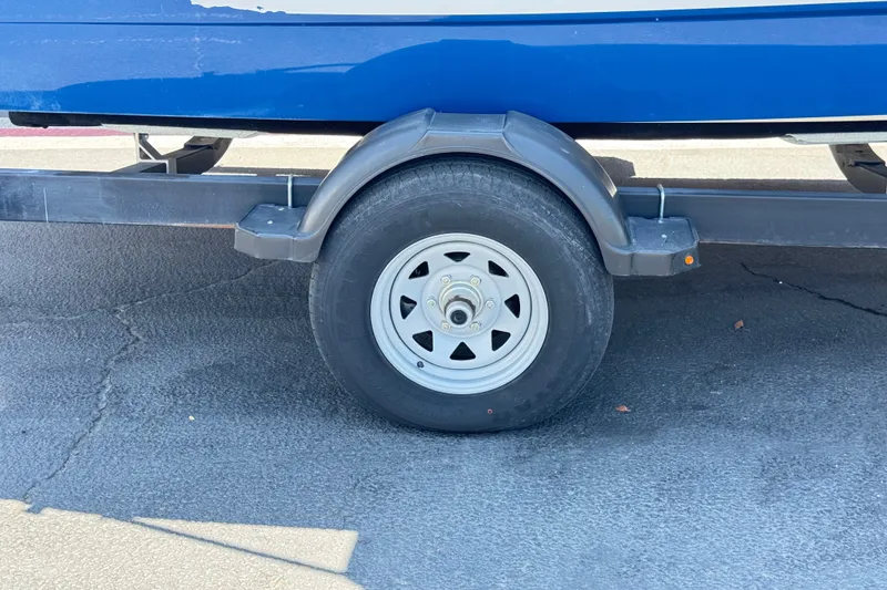 Slide: The Image of Trailer wheel of a 2019 Bayliner 195 Deck Boat on pavement. - 32
