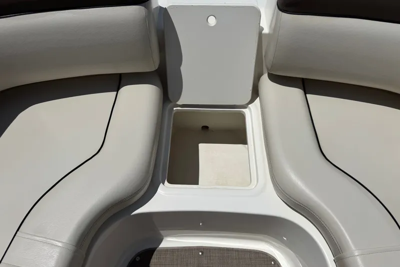 Slide: The Image of 2019 Bayliner 195 Deck Boat interior storage compartment with cushioned seating. - 16