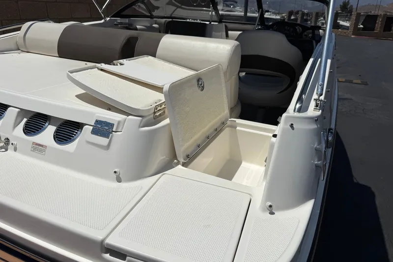 Slide: The Image of 2019 Bayliner 195 Deck Boat with open storage compartment and seating area. - 7