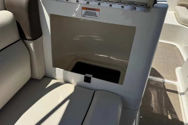 Slide: The Image of 2019 Bayliner 195 Deck Boat interior storage compartment with cushioned seating. - 23
