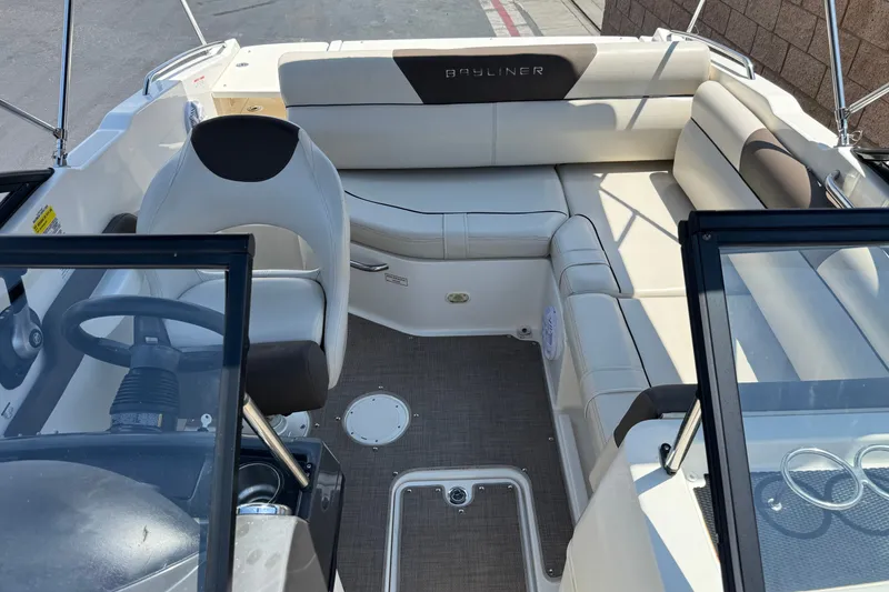 Slide: The Image of 2019 Bayliner 195 Deck Boat interior with seating and steering wheel. - 17