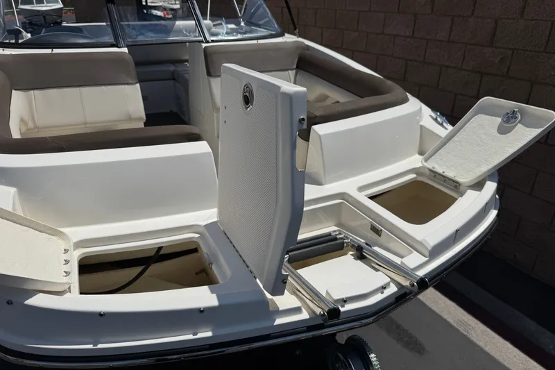 Slide: The Image of 2019 Bayliner 195 Deck Boat with open storage compartments and seating area. - 11