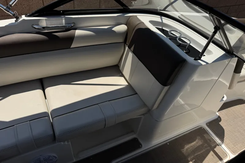Slide: The Image of Interior seating of a 2019 Bayliner 195 Deck Boat with cup holders and sleek design. - 22