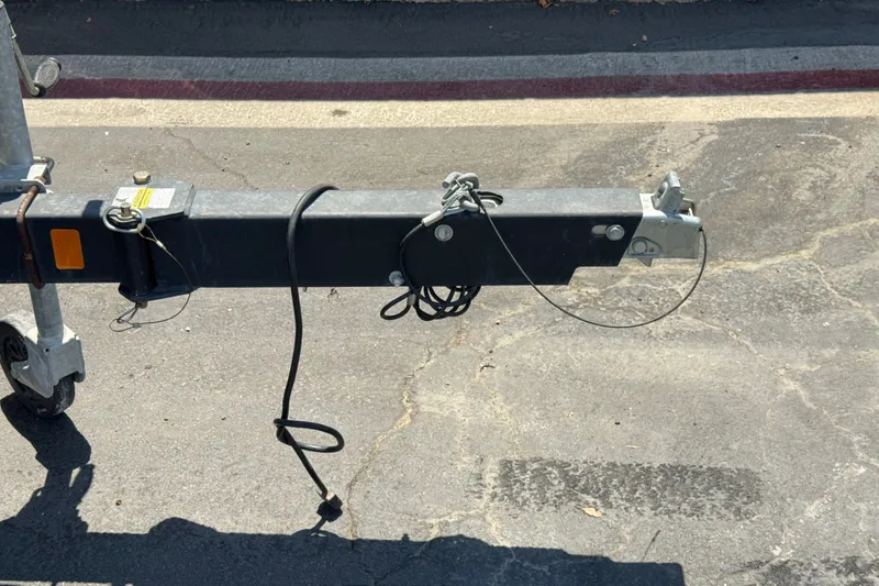 Slide: The Image of Trailer hitch of a 2019 Bayliner 195 Deck Boat on pavement. - 33