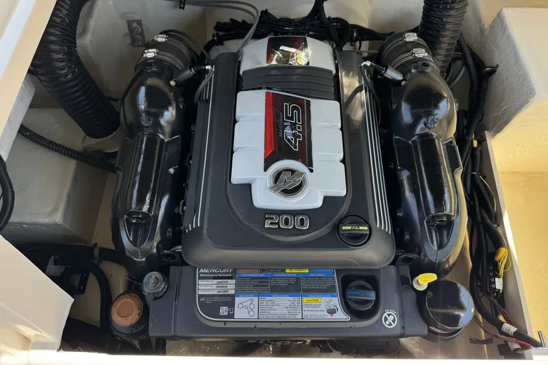 Slide: The Image of Engine compartment of a 2019 Bayliner 195 Deck Boat with a Mercury 4.5L 200 HP engine. - 19