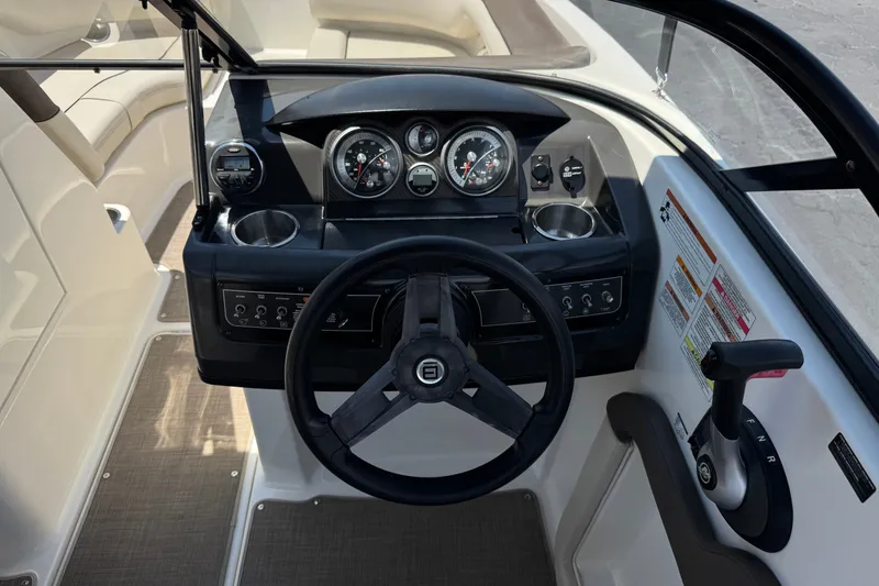 Slide: The Image of 2019 Bayliner 195 Deck Boat cockpit with steering wheel and instrument panel. - 27